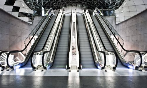 An interior shot of a building with escalators