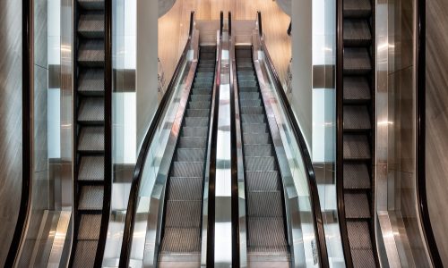 Modern escalator parallel moving in department store. Top view